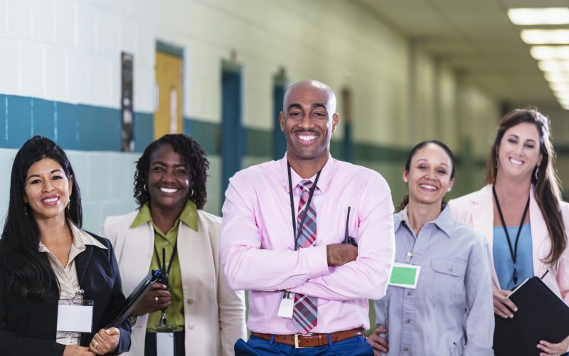 African-American man leads school staff